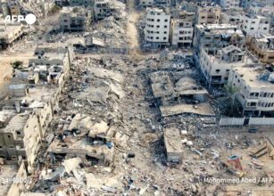 An aerial view on December 26, 2023 shows destroyed buildings in Beit Lahia following Israeli bombardments in the northern Gaza Strip. Mohammed Abed / AFP